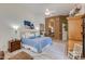 Bright main bedroom featuring a ceiling fan, plush blue bedding, and ensuite access at 4511 E Kirkland Rd, Phoenix, AZ 85050