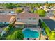 Expansive aerial view of the residence showcasing a private pool and lush backyard with a covered patio at 4563 E Libby St, Phoenix, AZ 85032