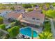Backyard aerial view of a home featuring a covered patio, a pool, and beautiful landscaping at 4563 E Libby St, Phoenix, AZ 85032