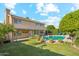 Beautiful backyard features a well-maintained lawn, pool, and covered patio at 4563 E Libby St, Phoenix, AZ 85032