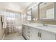 Bright bathroom with double sinks, quartz countertops, and decorative mirrors and fixtures at 4563 E Libby St, Phoenix, AZ 85032