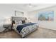 Cozy bedroom features a plush bed, a ceiling fan, and a window with natural light at 4563 E Libby St, Phoenix, AZ 85032