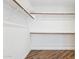 Spacious walk-in closet features wood floors and adjustable shelving and closet rod at 4563 E Libby St, Phoenix, AZ 85032