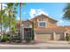 Charming two-story home with three-car garage, desert landscaping, and palm trees under a bright blue sky at 4563 E Libby St, Phoenix, AZ 85032
