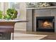 Close up view of a modern fireplace in the living room, featuring a lit fire and neutral colors at 4563 E Libby St, Phoenix, AZ 85032