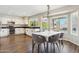 Open-concept kitchen with a dining area, marble table, and lots of natural light at 4563 E Libby St, Phoenix, AZ 85032