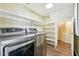 Well-organized laundry room with stainless steel washer and dryer, and storage shelving at 4563 E Libby St, Phoenix, AZ 85032