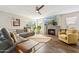 Comfortable living room featuring fireplace, mounted tv, wood floors, and ample natural light at 4563 E Libby St, Phoenix, AZ 85032