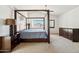 Spacious bedroom with a four-poster bed, dark wood furniture, and lots of natural light at 4563 E Libby St, Phoenix, AZ 85032