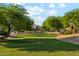 Community park with lush green lawn lined by mature trees offering a picturesque and serene setting at 4563 E Libby St, Phoenix, AZ 85032