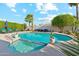 Inviting swimming pool with a spa, lounge chairs, desert landscaping, and blue skies at 4563 E Libby St, Phoenix, AZ 85032