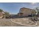 Large backyard with desert landscaping and a covered patio, perfect for outdoor living at 4990 E Odessa Dr, San Tan Valley, AZ 85140