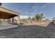 Backyard featuring a covered patio and low-maintenance desert landscaping at 4990 E Odessa Dr, San Tan Valley, AZ 85140