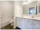 Bright bathroom with double sinks, white cabinetry, and a shower/tub combo at 4990 E Odessa Dr, San Tan Valley, AZ 85140