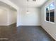 Well-lit dining room with tile floors, and a modern pendant light fixture at 4990 E Odessa Dr, San Tan Valley, AZ 85140