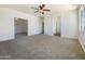 Large empty room with neutral carpet, white trim, and ceiling fan at 4990 E Odessa Dr, San Tan Valley, AZ 85140