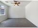 Empty bedroom featuring soft carpet, a ceiling fan, and a window providing natural light at 4990 E Odessa Dr, San Tan Valley, AZ 85140