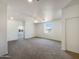 Well-lit empty room featuring neutral carpet, white trim, and a ceiling fan at 4990 E Odessa Dr, San Tan Valley, AZ 85140
