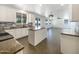 Bright, modern kitchen featuring white cabinets, an island, and stainless steel appliances at 4990 E Odessa Dr, San Tan Valley, AZ 85140