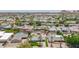Community aerial shot of homes nestled within mature greenery, including homes with pools and mountain views in the distance at 6255 E Rose Circle Dr, Scottsdale, AZ 85251