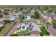 Aerial view highlighting a private backyard oasis with a pool, lush lawn, patio, pergola, and solar panels at 6255 E Rose Circle Dr, Scottsdale, AZ 85251