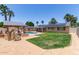 Lush backyard with a sparkling pool, covered patio, and well-maintained lawn, perfect for outdoor enjoyment at 6255 E Rose Circle Dr, Scottsdale, AZ 85251
