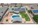 Overhead view showcasing a backyard with a pool, patio, cabana, green lawn, and solar panels for sustainable living at 6255 E Rose Circle Dr, Scottsdale, AZ 85251