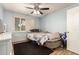 Bedroom featuring light blue walls, a ceiling fan, and shuttered windows at 6255 E Rose Circle Dr, Scottsdale, AZ 85251