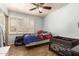 This bedroom features light blue walls, a ceiling fan, and shuttered windows at 6255 E Rose Circle Dr, Scottsdale, AZ 85251