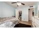 Bedroom featuring light blue walls, a ceiling fan, and shuttered windows with closet at 6255 E Rose Circle Dr, Scottsdale, AZ 85251