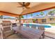 Enjoy outdoor gatherings in this spacious covered patio with a kitchen, dining area, and pool views at 6255 E Rose Circle Dr, Scottsdale, AZ 85251
