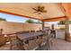 Spacious covered patio with a full outdoor kitchen and ample seating for comfortable outdoor living at 6255 E Rose Circle Dr, Scottsdale, AZ 85251