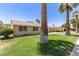 View of the home's side yard with lush grass and mature landscaping at 6255 E Rose Circle Dr, Scottsdale, AZ 85251