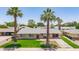 Charming single-story home with a well-manicured lawn and mature palm trees, offering curb appeal at 6255 E Rose Circle Dr, Scottsdale, AZ 85251