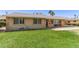Well maintained single-story home with a mature, green front lawn at 6255 E Rose Circle Dr, Scottsdale, AZ 85251