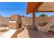 Inviting outdoor fireplace and hammock by the covered patio create a cozy backyard retreat at 6255 E Rose Circle Dr, Scottsdale, AZ 85251