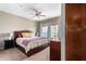 Comfortable bedroom featuring a ceiling fan, plush carpet, and a large window with ample natural light at 6745 N 93Rd Ave # 1129, Glendale, AZ 85305
