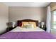Bright bedroom with plush bedding, a bedside table with lamps, and a window offering plenty of natural light at 6745 N 93Rd Ave # 1129, Glendale, AZ 85305