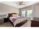 Comfortable bedroom featuring a ceiling fan, plush carpet, and a large window with ample natural light at 6745 N 93Rd Ave # 1129, Glendale, AZ 85305
