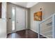 Bright entryway with hardwood floors, staircase, and contemporary artwork at 6745 N 93Rd Ave # 1129, Glendale, AZ 85305