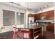 Bright kitchen featuring dark wood cabinets, stainless steel appliances, and granite countertops, offering style and functionality at 6745 N 93Rd Ave # 1129, Glendale, AZ 85305