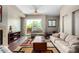 Cozy living area featuring hardwood floors, comfortable seating, and a sliding glass door to a balcony with natural light at 6745 N 93Rd Ave # 1129, Glendale, AZ 85305