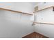 Bright walk-in closet featuring carpeted floors and wall mounted hanging racks with room for ample storage at 6745 N 93Rd Ave # 1129, Glendale, AZ 85305