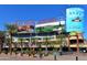 View of the Westgate Entertainment District with outdoor dining, palm trees, and water features on a sunny day at 6745 N 93Rd Ave # 1129, Glendale, AZ 85305