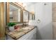 Bathroom vanity with granite countertop, decorative mirrors, and ample lighting at 6802 S 47Th St, Phoenix, AZ 85042