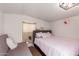 Small bedroom featuring a bed, futon, and natural light coming through the window at 6802 S 47Th St, Phoenix, AZ 85042