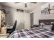 Comfortable bedroom with a plaid bedspread, a ceiling fan, and a view of the closet at 6802 S 47Th St, Phoenix, AZ 85042