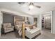 Spacious bedroom with a large bed, decorative seating, and ceiling fan at 6802 S 47Th St, Phoenix, AZ 85042