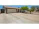 View of the home's exterior and driveway, showing the two-car garage and 'Beware of Dog' sign at 6802 S 47Th St, Phoenix, AZ 85042