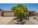 Charming single-story home featuring a xeriscaped front yard, mature tree, and a neutral color palette at 6802 S 47Th St, Phoenix, AZ 85042